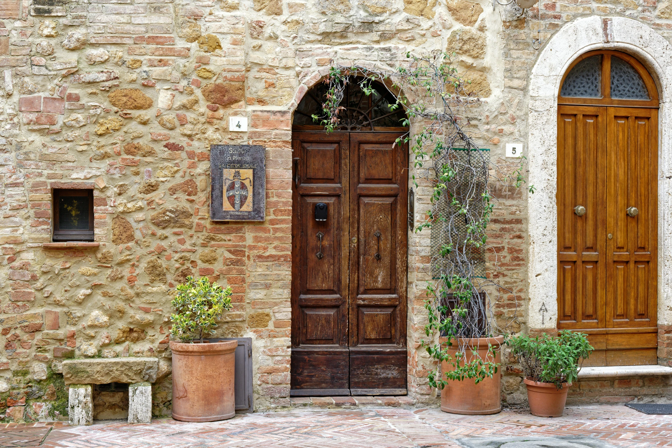 two tall wooden doors and a brown stone building