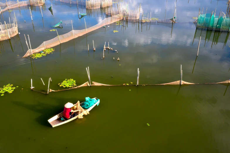 an aerial view of a small boat with people in it and lots of water