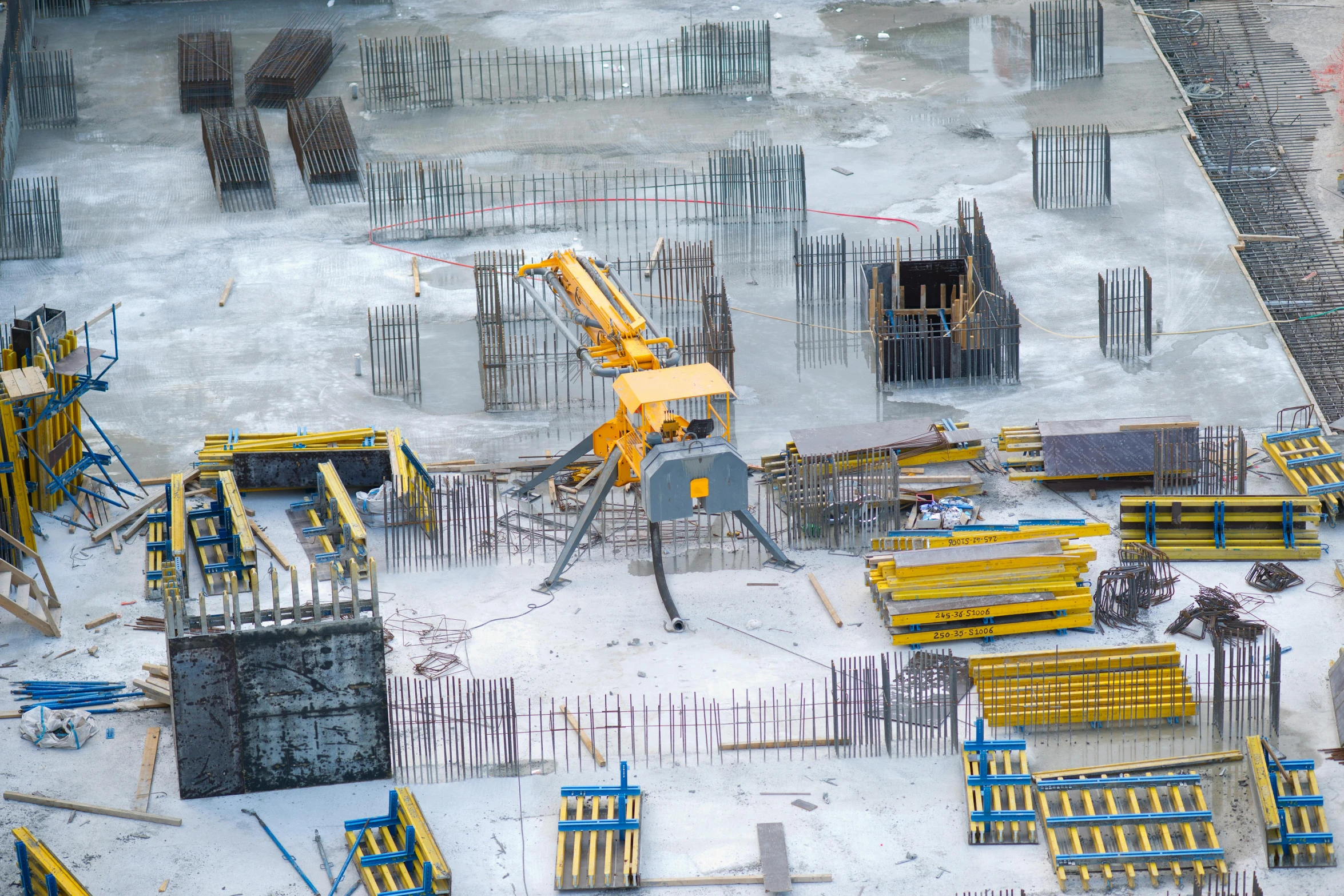 a yellow excavator is moving around construction