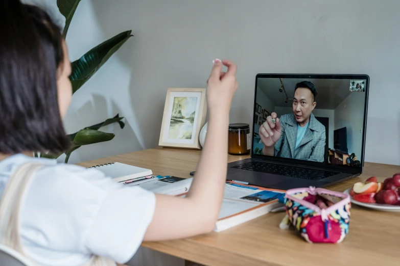 a lady that is sitting in front of a laptop