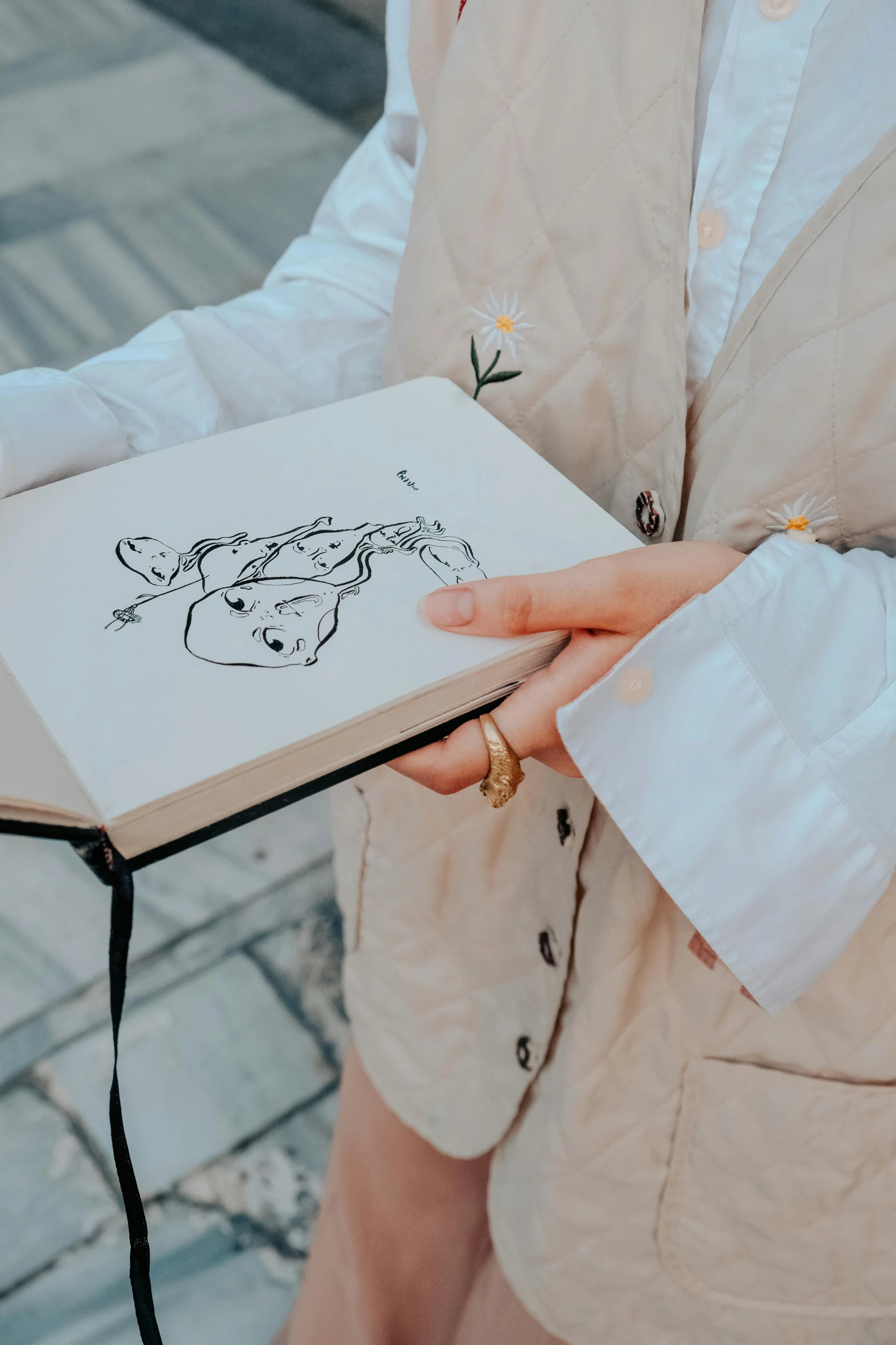 a person is holding a small book in their hands