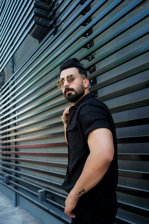 a man leaning against the side of a building