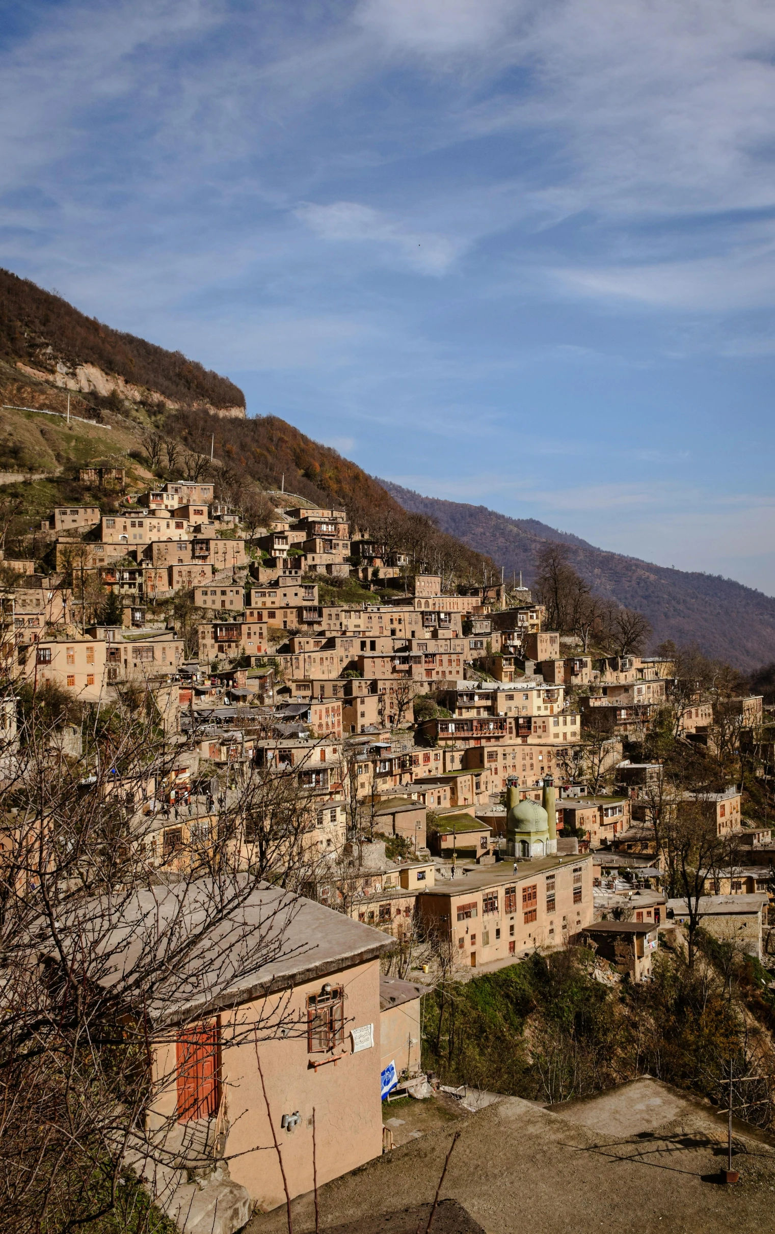 a hill with a very small village and buildings on it