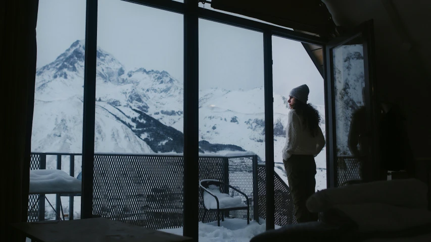 a person standing on a balcony next to some windows