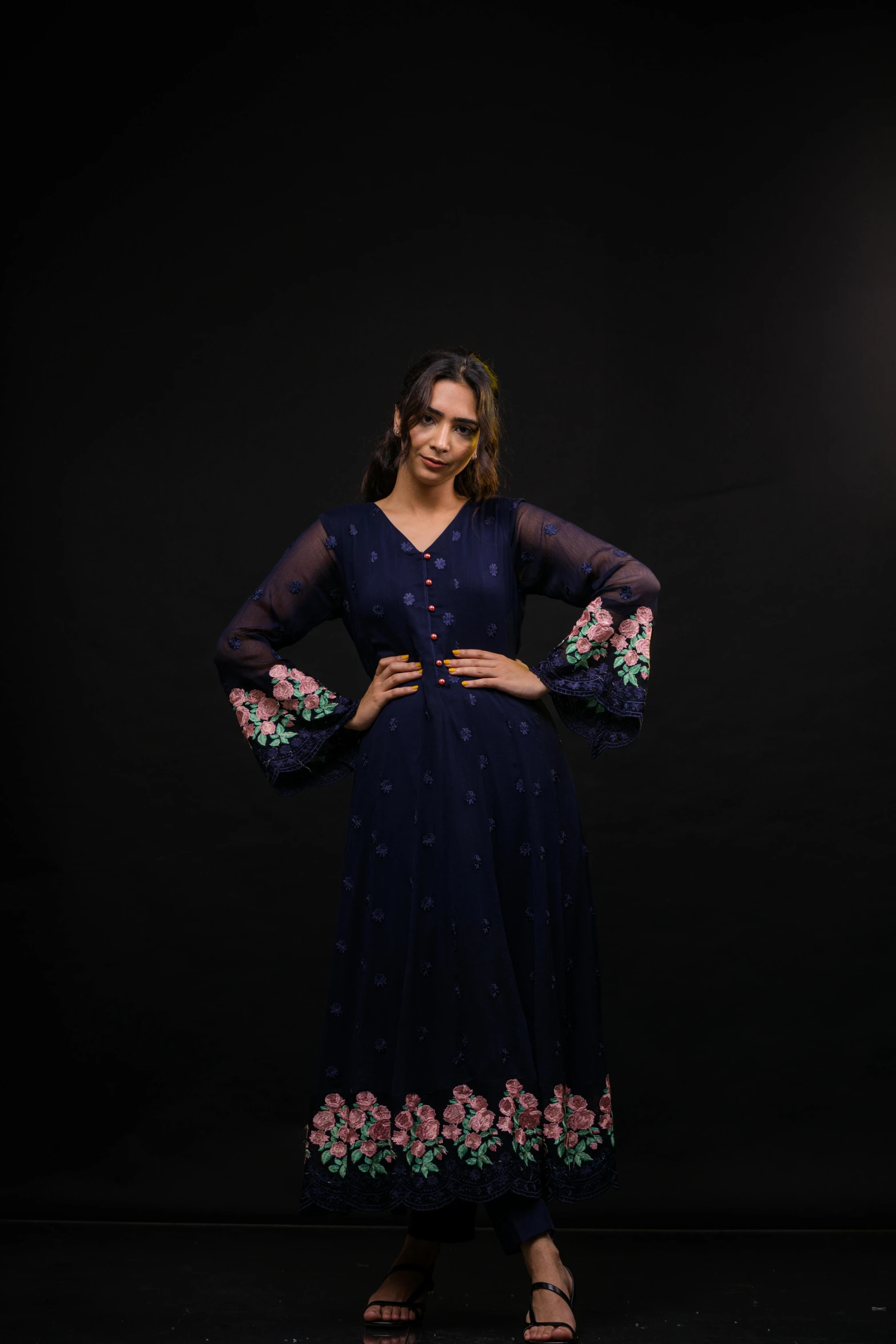 a women in a dark blue dress standing