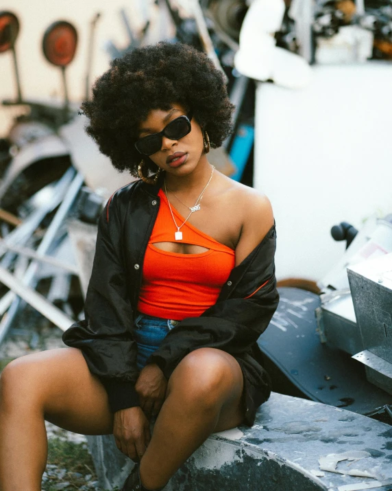 a woman with a serious look wearing an orange top