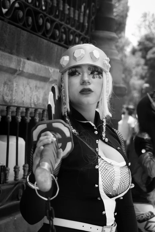 woman in hat and top with metal chain around neck