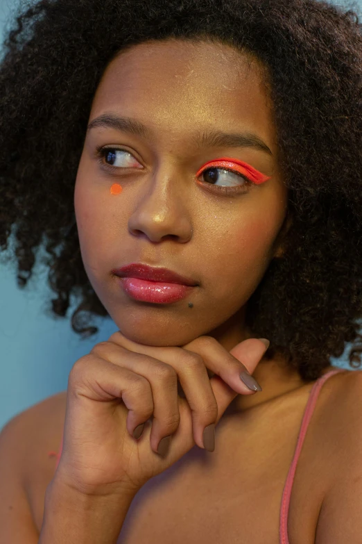 woman wearing orange, orange and yellow eye shadow makeup