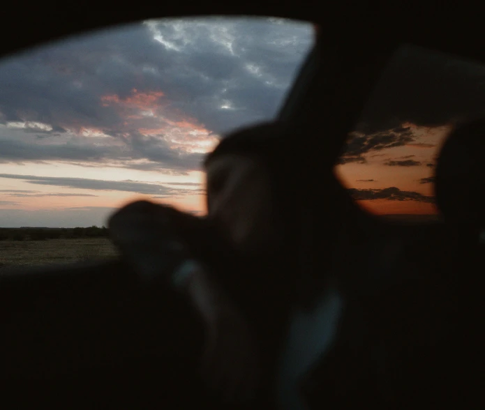 a dark night seen from the back of a car with its interior lights on