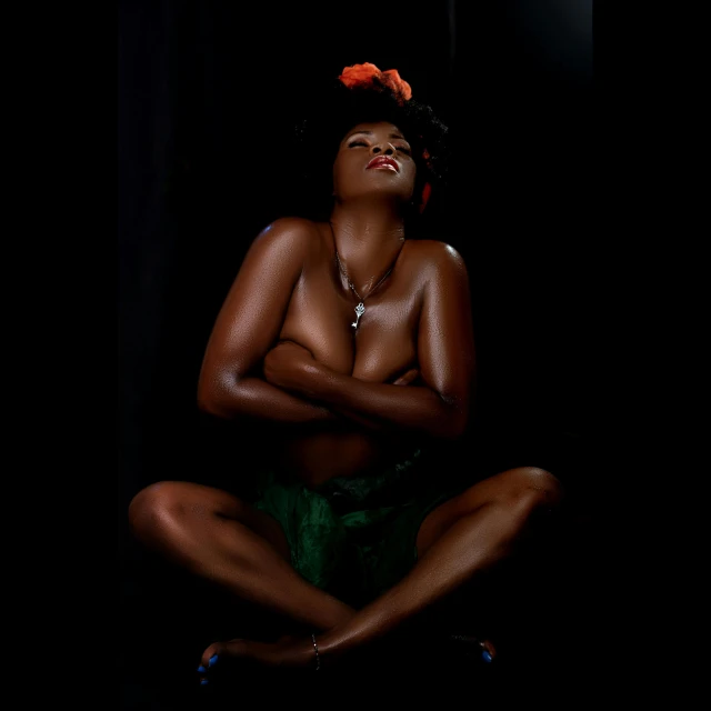 an african american  model is posed in the dark
