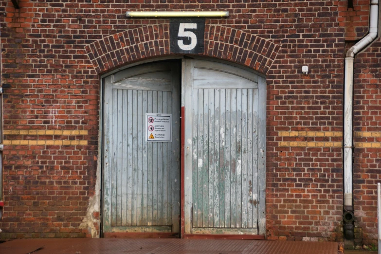 a building with two open doorways in the wall