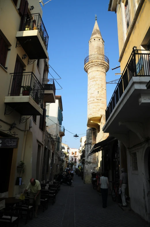 the narrow street leads to two stone buildings