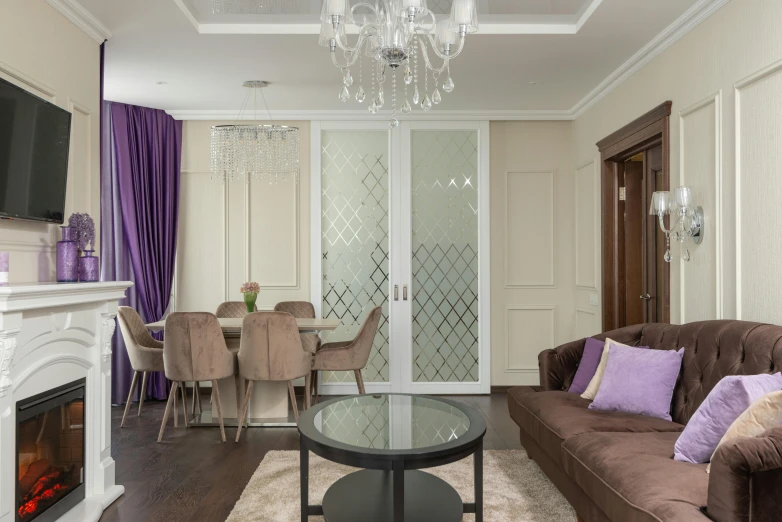 a living room with a brown couch and glass tables