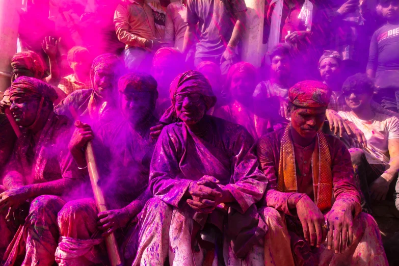 people with a lot of colors sitting on the ground