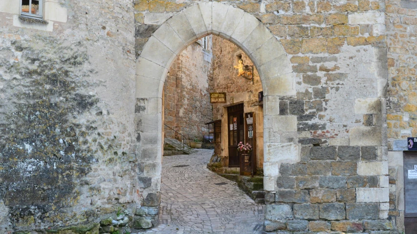 a building that has an archway way leading to a store