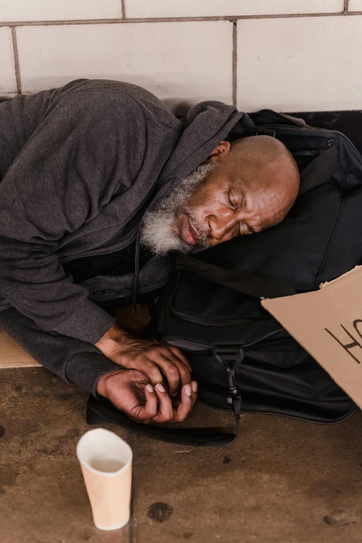 an old man sitting on the floor of a building