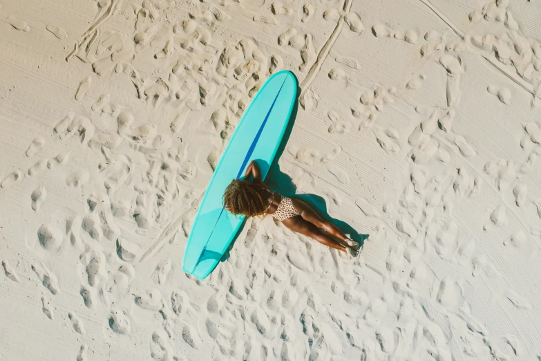 an overhead view of a person laying on a surfboard