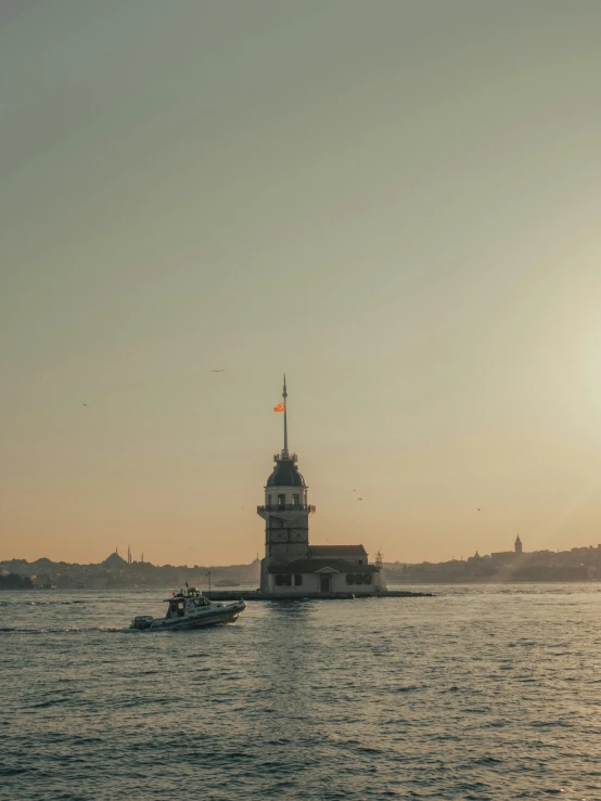 a light tower is on an island off of the water