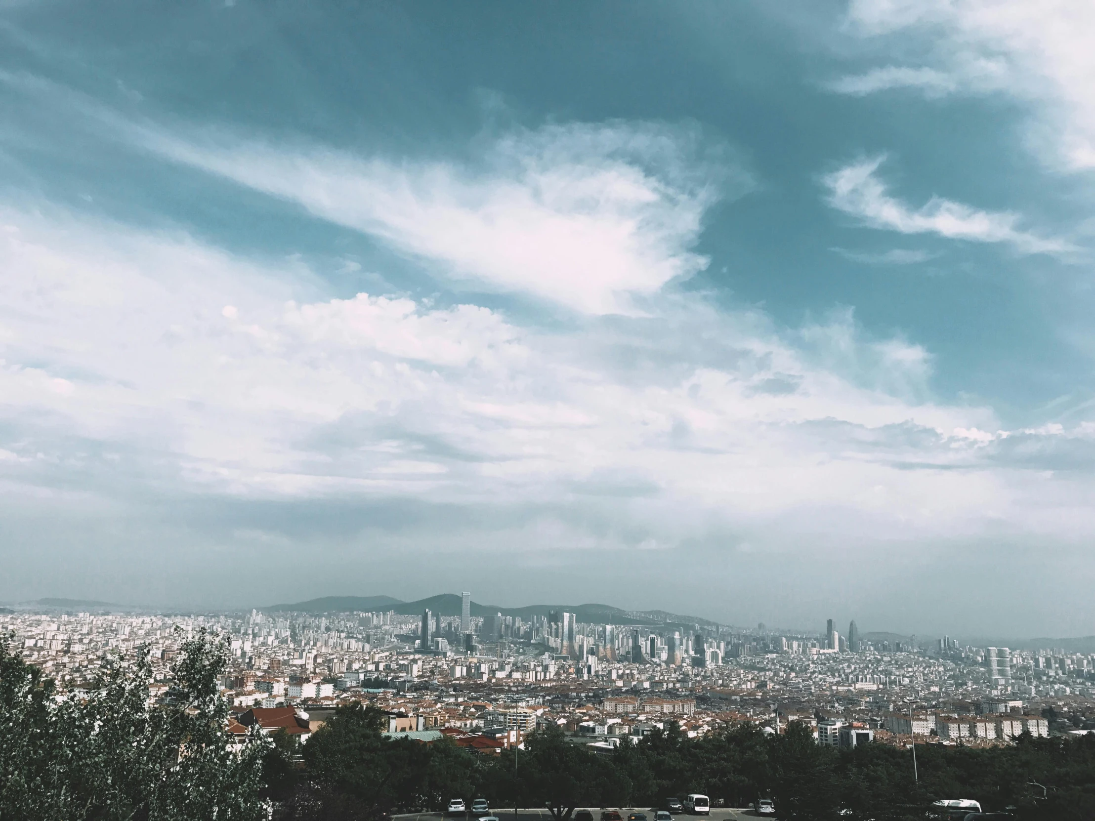 city skyline with a large body of water in foreground