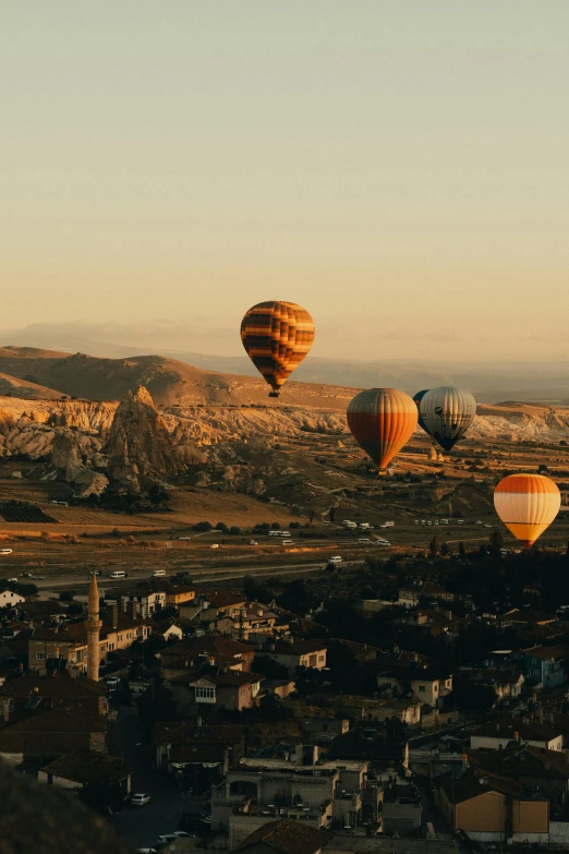 several balloons are flying over a mountain range