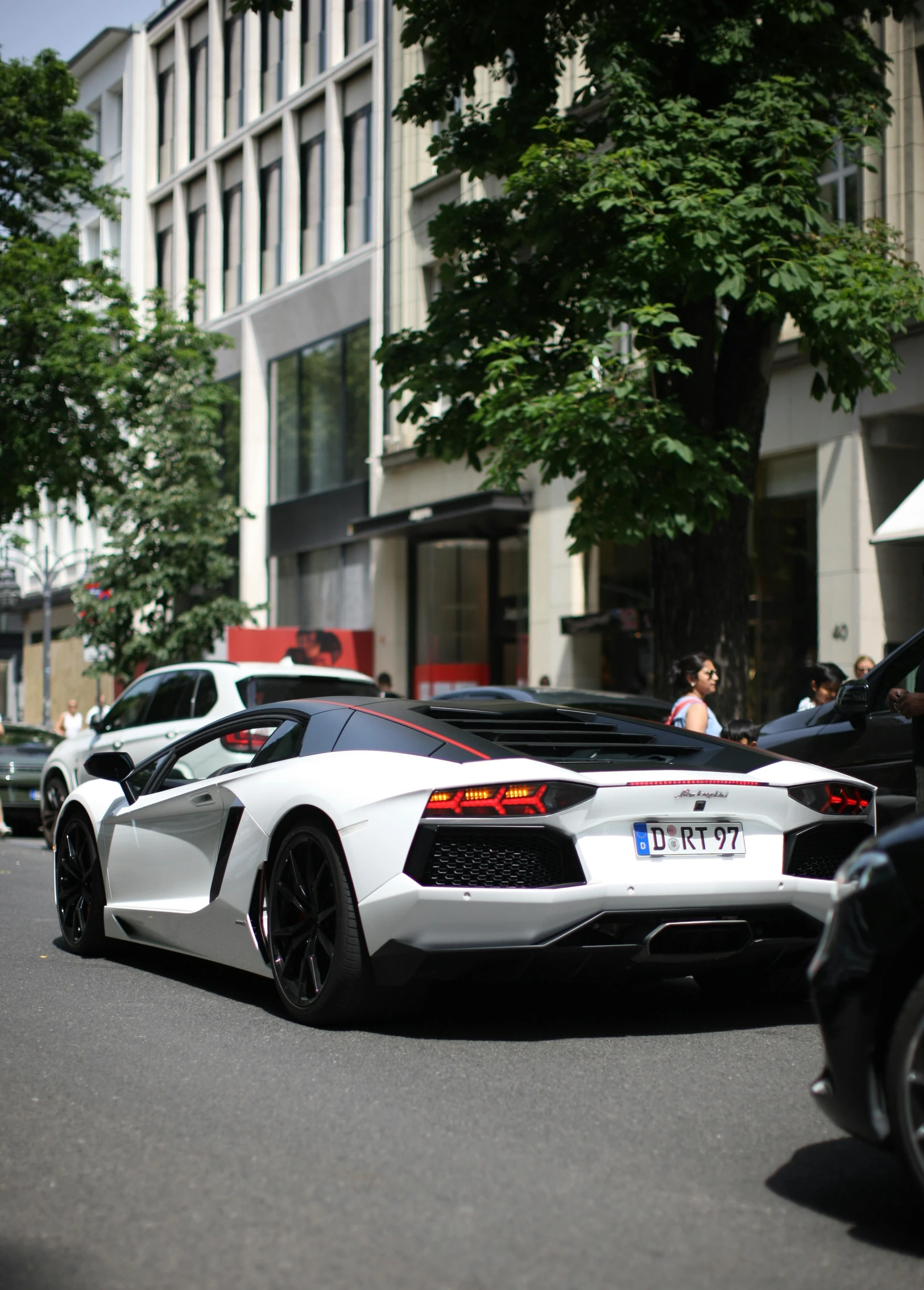 several different colored cars are lined up on the street