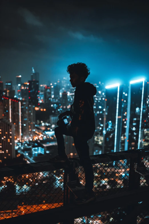 a man standing on the edge of a rooftop at night