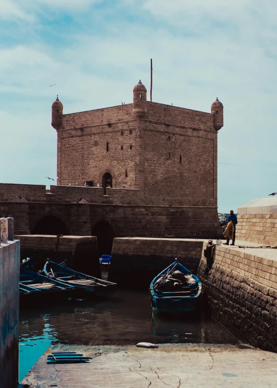 a building sits along the side of a body of water