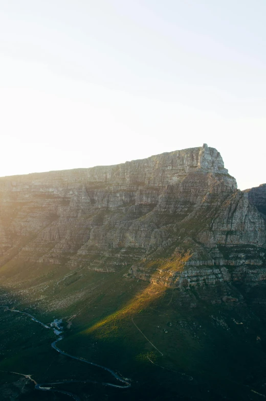 a view of the top of a mountain at sunset