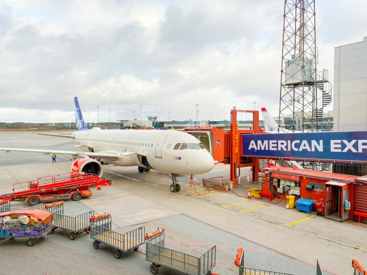 a airplane parked next to an airport on the tarmac