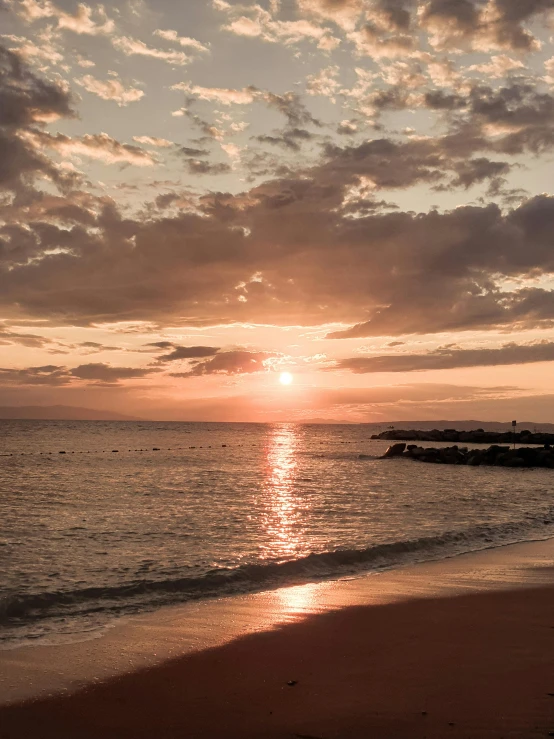 a view of the sun set on the ocean