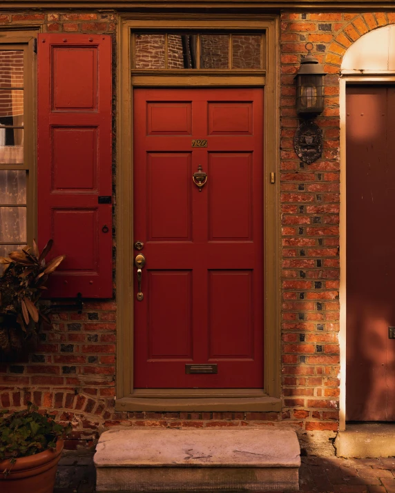 the red front doors are shown next to brick wall