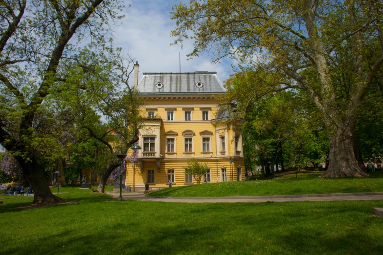 an old building is shown with trees around it