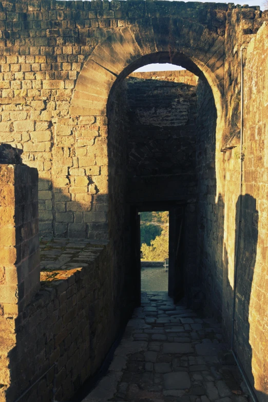 a narrow walkway leads into an archway leading to nowhere