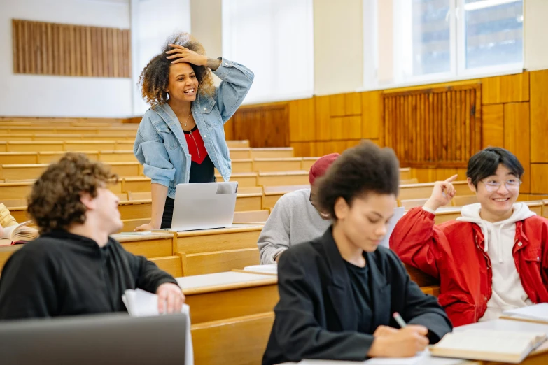 a woman in a blue jacket at a lecture hall