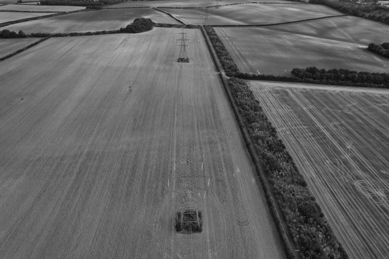 a plow drives along a large grass field