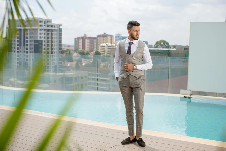 a man stands on a dock by the edge of an empty pool