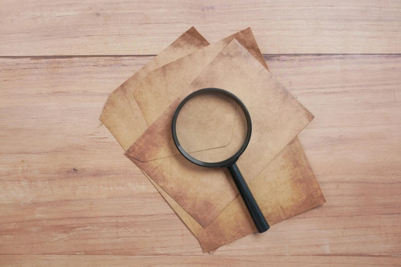 a magnifying glass on top of old paper