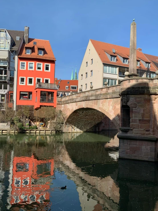 buildings surrounding a waterway, with the bridge over water