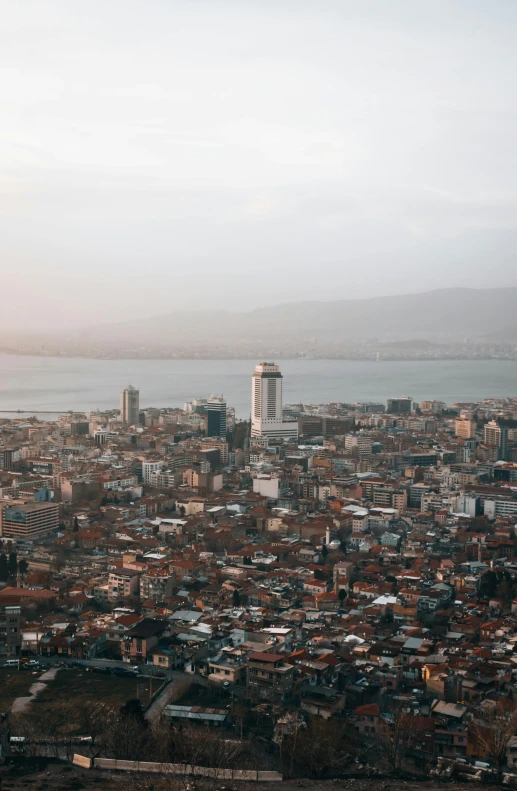 an aerial view of a city with water in the background