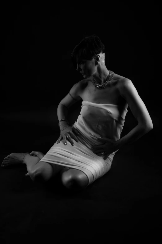 a woman posing in front of a black background