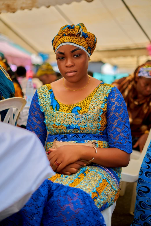 a young woman wearing an african head wrap