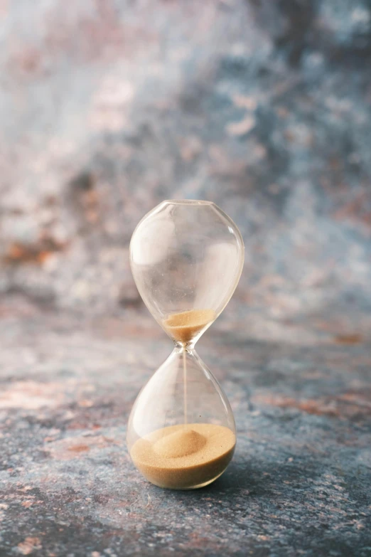 sand in an hourglass going uphill in order to reach a quarter