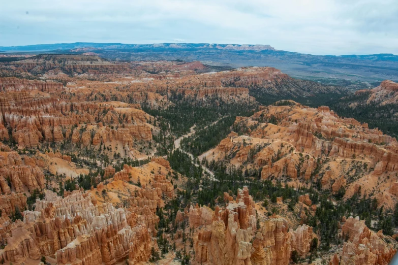 the sky view over a landscape consisting of mountains and trees