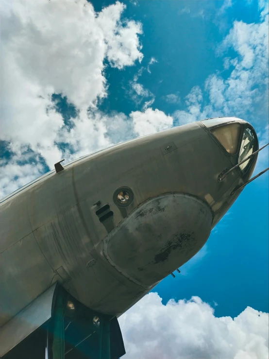 the nose of an old airplane against the blue sky