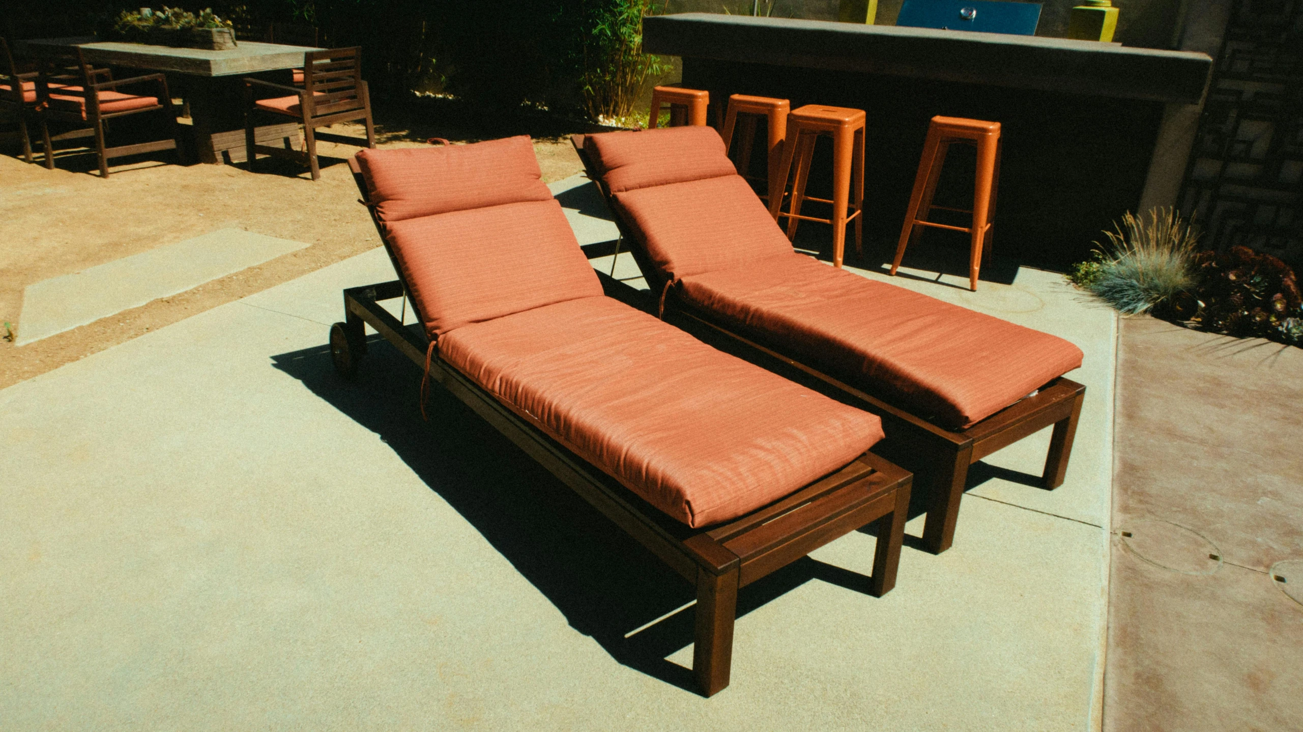 an outdoor patio with chairs and table next to an outside terrace