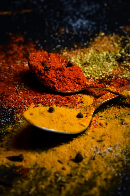 spoons with various spices placed on top of them