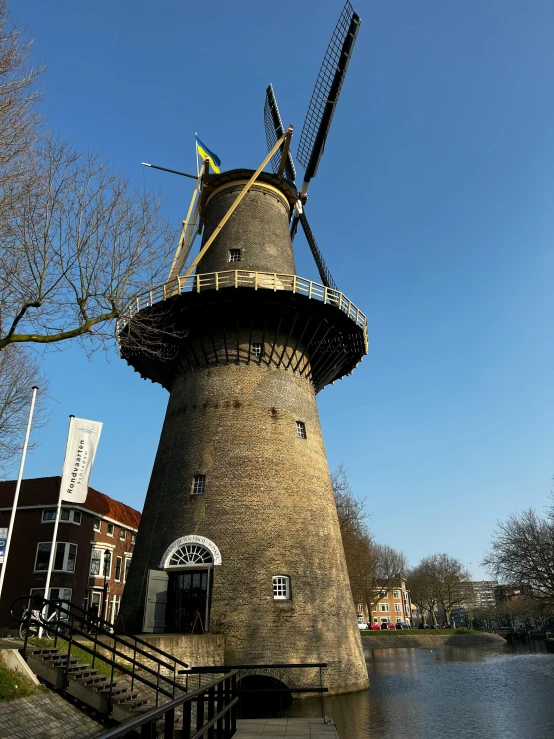 windmill in the middle of a pond on a sunny day