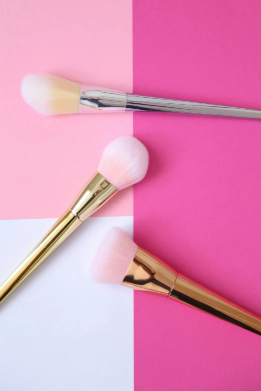 this is an image of cosmetics brushes on two different colored squares