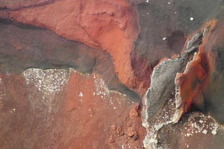 aerial view of red and brown dirt with white stuff