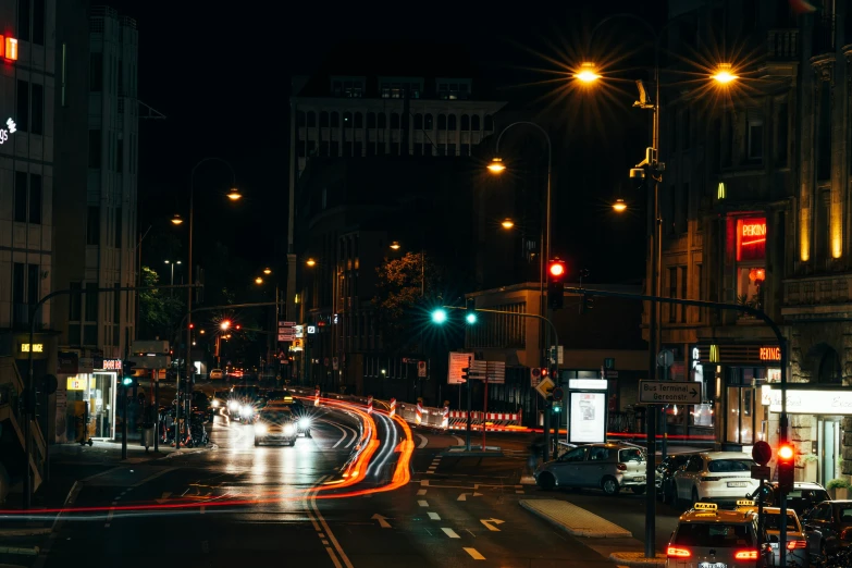 cars passing by on a city street at night